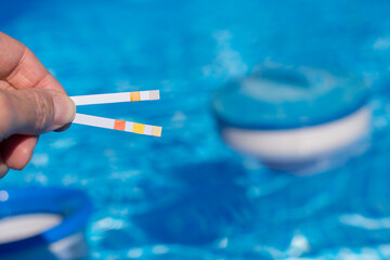 Person Measuring In The Pool With Test Strips Important Values