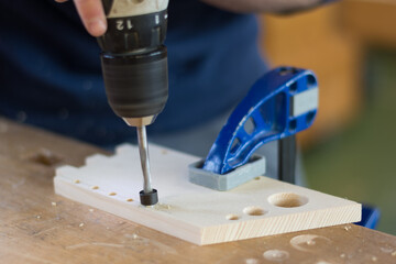Person Drills Holes In Wood