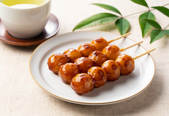 Mitarashi dango and green tea placed on a cloth