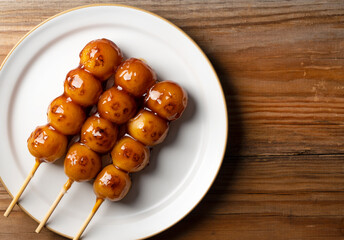 Mitarashi dango placed on a wooden background