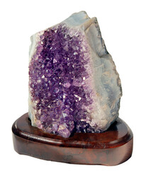 Raw fragment of Amethyst mineral gem stone on wooden seat, purple crystals isolated on white...