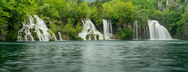 wide long exposure shot of several waterfalls at plitvice lakes national park