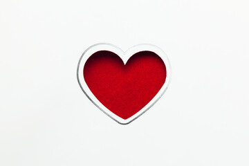 white postcard with red heart shape textile background