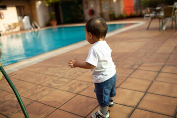 Cute Little Boy Looking At The Swimming Pool