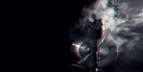 metal hookah bowl with hot coals on a background with smoke
