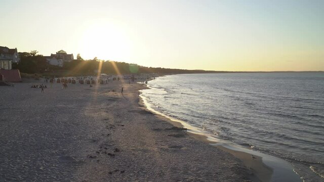 overlook over beautiful sunset at beach at baltic sea with sunstar and waves rolling in