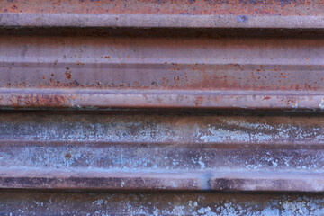 Sheet of metal rusty texture with traces of purple paint faint color corroded with age in Sofia, Bulgaria, Eastern Europe