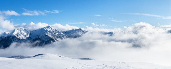 Ski resort landscape on clear sunny day. Panoramic view of mountains near Brianson, Serre Chevalier resort. Mountain ski resort. Snow slope. Snowy mountains. Winter vacation.