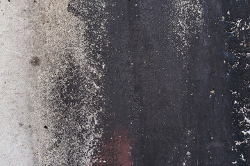 Grey texture of old broken asphalt road or wall big abrasions cracks holes on the surface pebbles cement in Sofia, Bulgaria, Eastern Europe