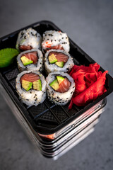 Japanese food delivery. Rolls with salmon and avocado in box
