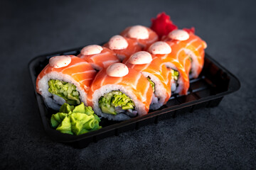Traditional Japanese rolls with salmon and cucumber in box