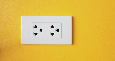The power sockets on the walls are painted in bright yellow.