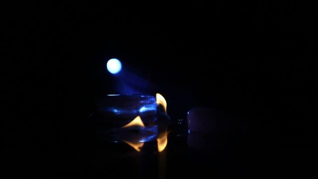Valentines background. Valentine's Day heart on a dark wooden table. Burning ice hearts. Heart in fire. Dark toned foggy background. Selective focus