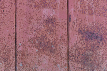 Plate of metal rusty texture with traces of red paint faint color corroded with age in Sofia, Bulgaria, Eastern Europe