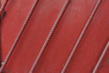 Steel rods added on door or wall for extra protection spray painted in red texture or background rare concept from Sofia, Bulgaria, Eastern Europe
