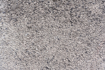 Flat texture of small grey and white pebbles background concrete asphalt road or building wall surface in Sofia, Bulgaria, Eastern Europe