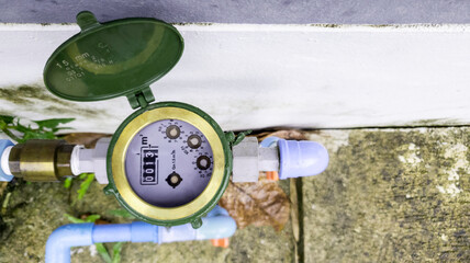 Water meter on concrete background, Measuring device, Open cover of water meter to check counter...
