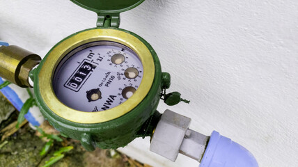Water meter on concrete background, Measuring device, Open cover of water meter to check counter...