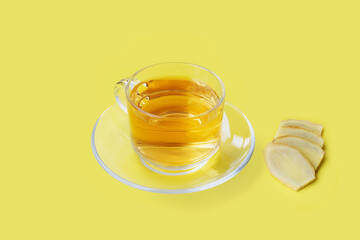 Hot ginger tea, ale with ginger slice on yellow background - Healthcare herb and spice