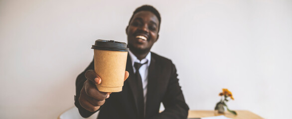 African american man sitting holding coffee cup in Coffee shop