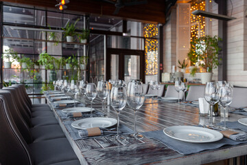 Modern veranda restaurant interior, banquet setting, glasses, plates - obrazy, fototapety, plakaty