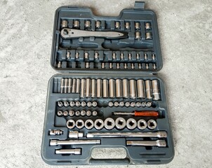 An open tool box placed on the above view. Car accessories or spare parts, garage.