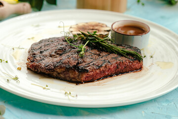 Grilled juicy beef steak medium roast with rosemary and pepper sauce