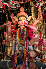 Idol of Goddess Devi Durga at a decorated puja pandal in Kolkata, West Bengal, India. Durga Puja is...