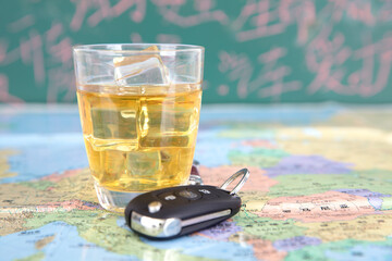 A glass of wine and car keys on the traffic map