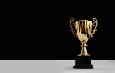golden trophy cup with copy space on black background