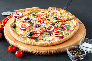 cooked hot pizza pie with pepperoni, tomatoes, black olives, arugula and mozzarella on wooden board.
