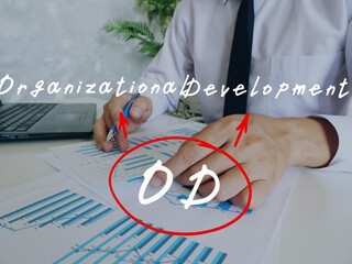 Financial concept about OD Organizational Development with handwritten note.Businessman hands...