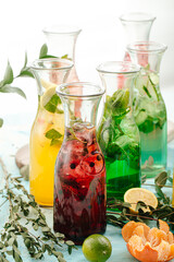 Side view on assorted fresh fruit lemonades with herbs