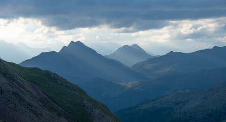 Naklejka premium Panorama from Rifugio Cassana, Italy, into the mountains. Sunshine through cloud