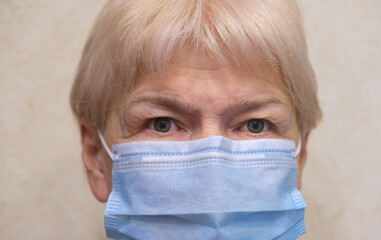Close up senior woman  wearing face mask during corona virus and flu outbreak. Disease and illness protection.
