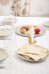 Jewish flatbread matzo on table setting for Passover Seder