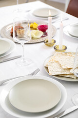 Jewish flatbread matzo on table setting for Passover Seder
