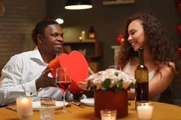 African-American man greeting his girlfriend on Valentine's Day at home