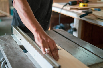 texture of color wood dust sparks over the table, view in the carpenter workshop.