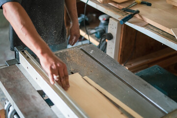 texture of color wood dust sparks over the table, view in the carpenter workshop.