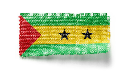 Sao Tome and Principe flag on a piece of cloth on a white background