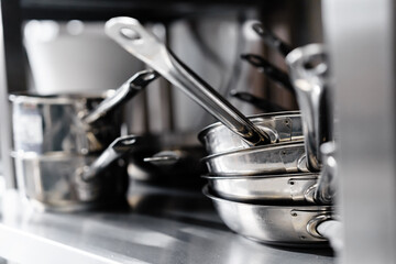 Kitchen utensils on work surface in professional kitchen