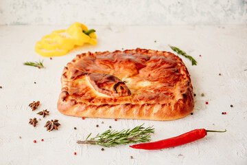 Pie with red fish and rice, baking on a light background, top view