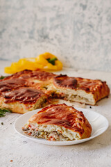 Pie with red fish and rice, baking on a light background, top view