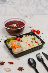 Lunch boxes: dishes in disposable plastic dishes, Russian cuisine - borsch, soup, rice, vegetables, pasta, meat cutlets, mushrooms. Top view