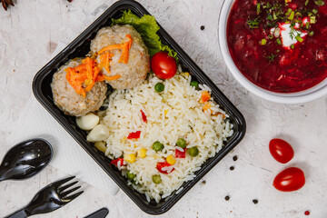 Lunch boxes: dishes in disposable plastic dishes, Russian cuisine - borsch, soup, rice, vegetables, pasta, meat cutlets, mushrooms. Top view