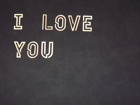 the words I love you and hearts made of wood on Valentine's day. High quality photo