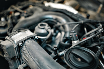 Obraz na płótnie Canvas Dirty engine under the hood of a car