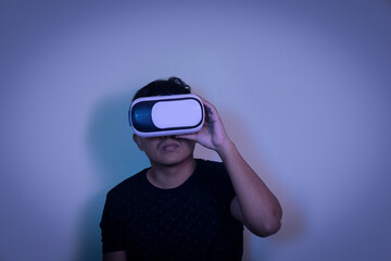 A man wearing virtual reality glasses touches video and new technology.