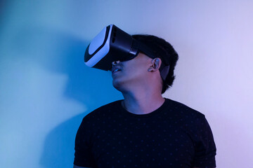 A man wearing virtual reality glasses touches video and new technology.